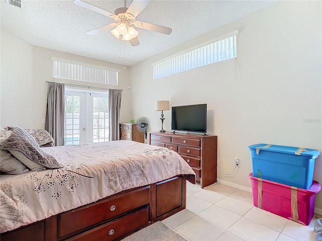 bedroom featuring a textured ceiling, french doors, access to outside, light tile patterned flooring, and ceiling fan