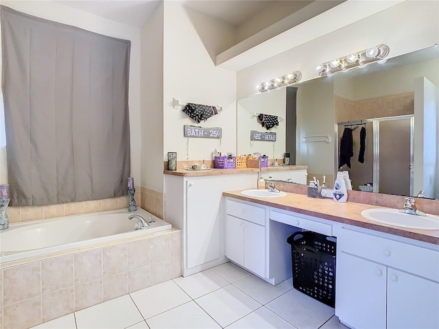 bathroom featuring shower with separate bathtub, tile patterned floors, and vanity