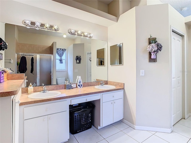 bathroom featuring toilet, tile patterned flooring, an enclosed shower, and vanity