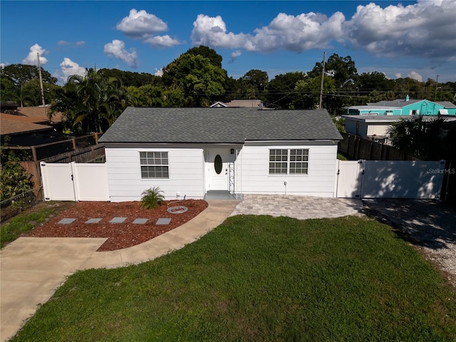 view of front of house with a patio area and a front lawn