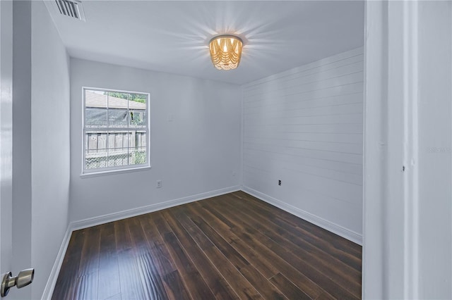 empty room with dark wood-type flooring