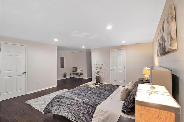 bedroom with electric panel and dark hardwood / wood-style floors