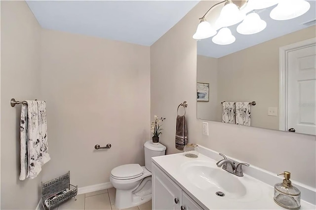 bathroom featuring vanity, tile patterned floors, and toilet