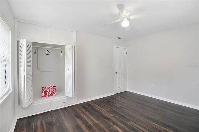 interior space with dark wood-type flooring, a closet, and ceiling fan