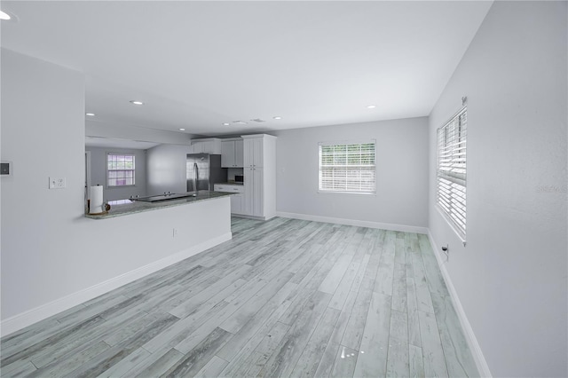 unfurnished living room with light wood-type flooring