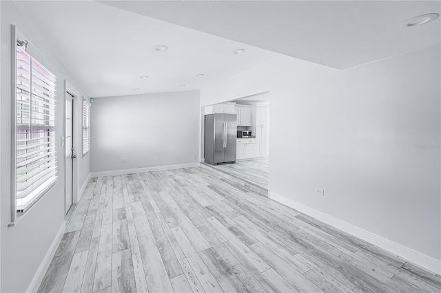 unfurnished room with light hardwood / wood-style floors