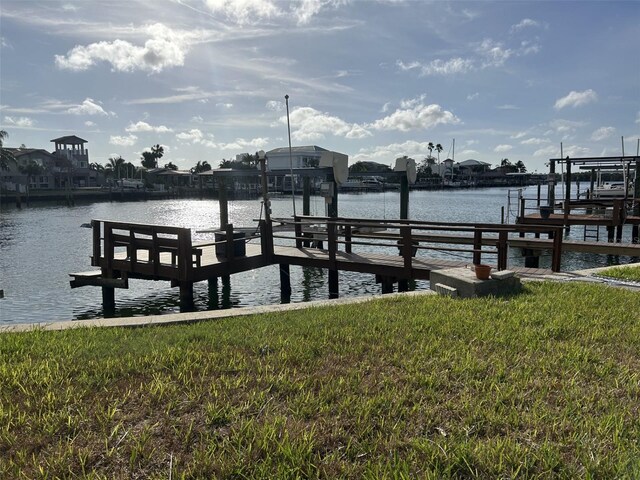 dock area featuring a yard and a water view