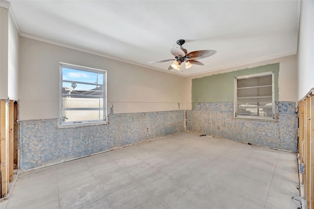 spare room featuring ornamental molding and ceiling fan