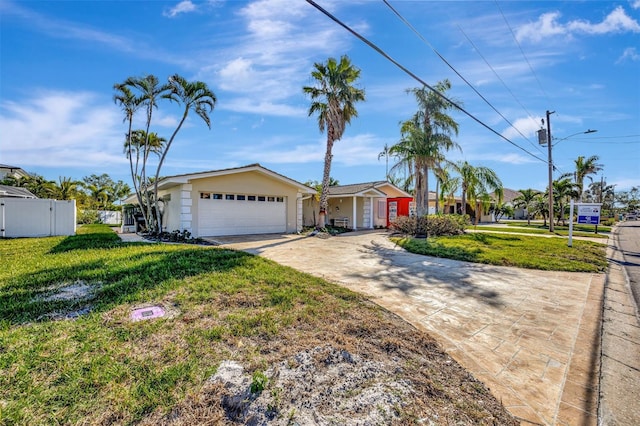 single story home with a garage and a front lawn