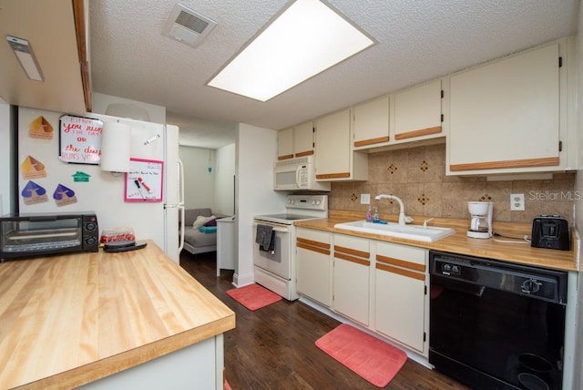 kitchen with white appliances, dark hardwood / wood-style floors, sink, and decorative backsplash