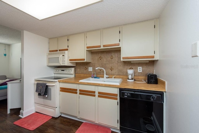 kitchen with dark hardwood / wood-style flooring, backsplash, white appliances, and sink