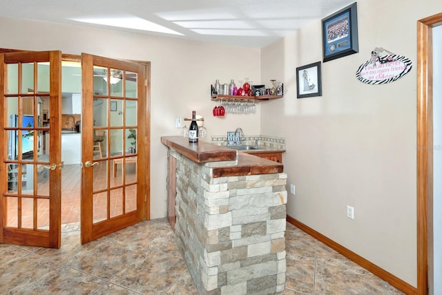 bar with sink and french doors