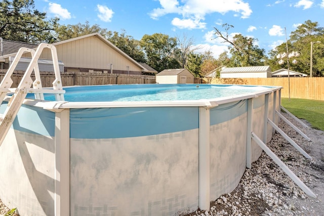 view of swimming pool featuring a storage shed