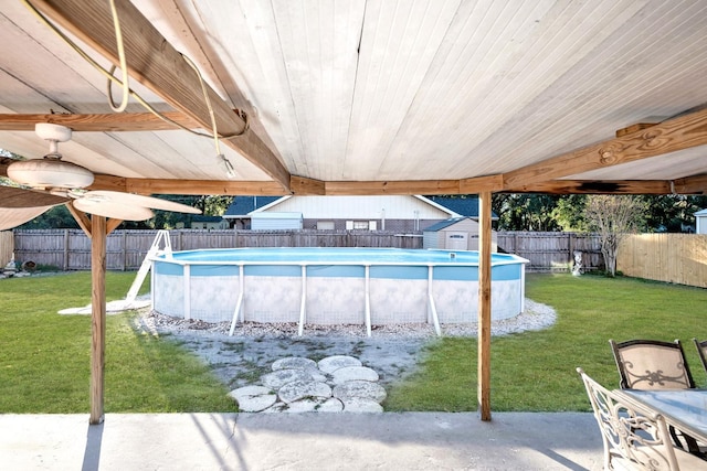 view of swimming pool with a lawn