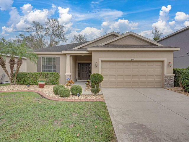 single story home with a garage and a front lawn