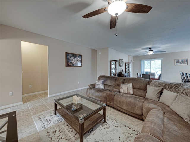 living room featuring light tile patterned flooring and ceiling fan