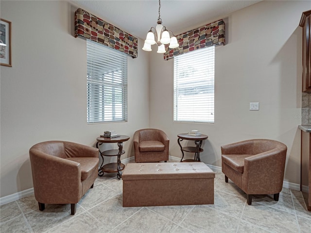 sitting room with a chandelier and light tile patterned floors