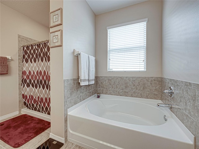 bathroom featuring shower with separate bathtub