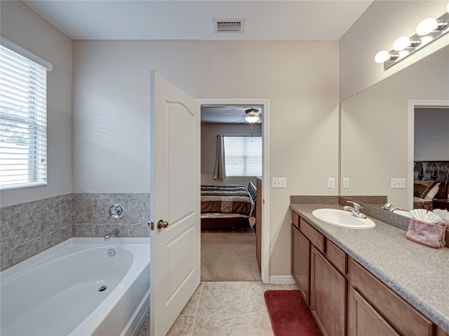 bathroom featuring tile patterned floors, vanity, a healthy amount of sunlight, and ceiling fan