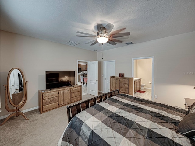 carpeted bedroom featuring ensuite bathroom, ceiling fan, and a textured ceiling