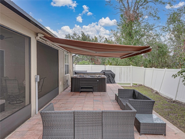 view of patio / terrace with a hot tub