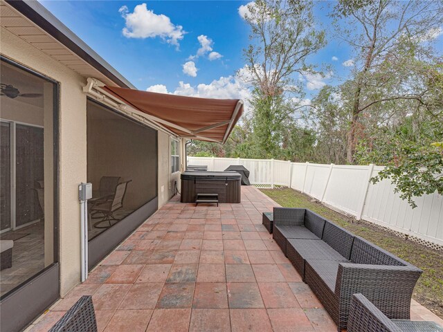 view of patio / terrace featuring a hot tub and grilling area