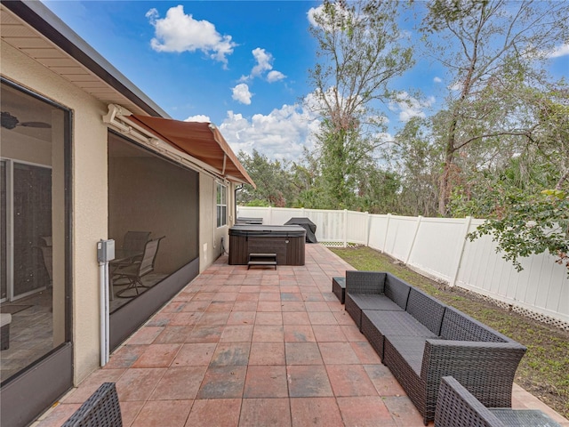 view of patio / terrace with a hot tub