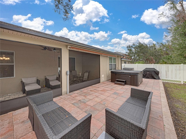 view of patio / terrace with ceiling fan and a hot tub