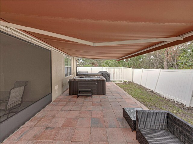 view of patio / terrace with a hot tub