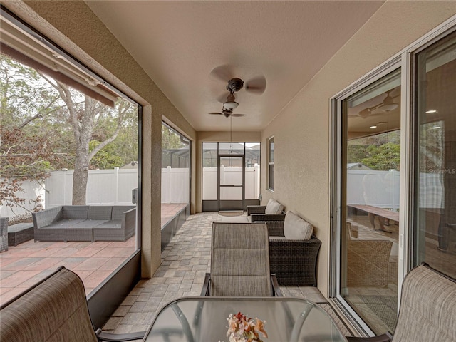 sunroom / solarium featuring ceiling fan and a healthy amount of sunlight