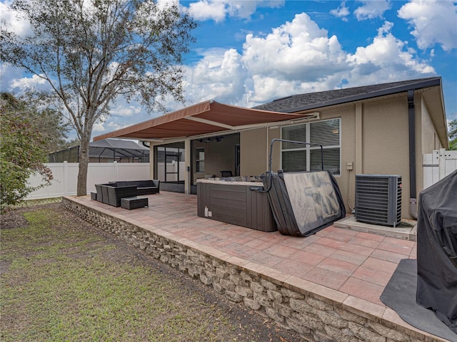 back of property with central air condition unit, a patio, a hot tub, and an outdoor hangout area