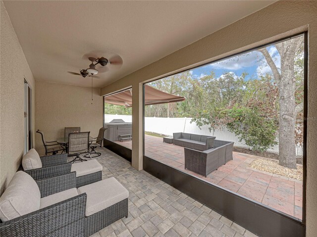 view of patio / terrace with ceiling fan and an outdoor living space