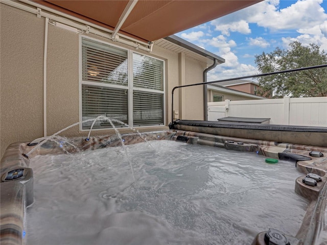 view of patio / terrace with a hot tub