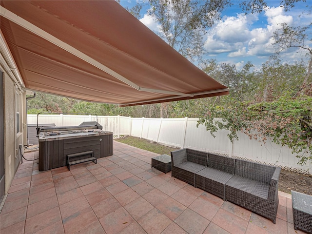 view of patio / terrace with a hot tub