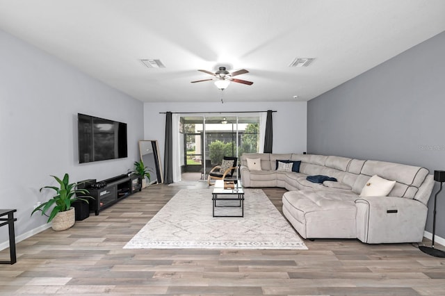 living room with light wood-type flooring and ceiling fan