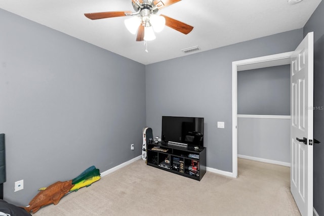 misc room featuring ceiling fan and light carpet