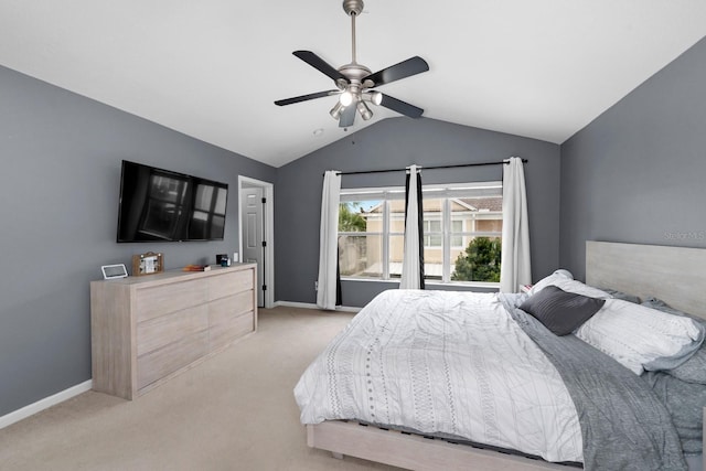 bedroom featuring vaulted ceiling, light colored carpet, and ceiling fan