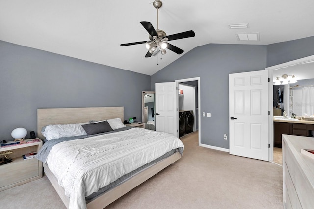 carpeted bedroom with sink, ensuite bathroom, ceiling fan, lofted ceiling, and washing machine and clothes dryer