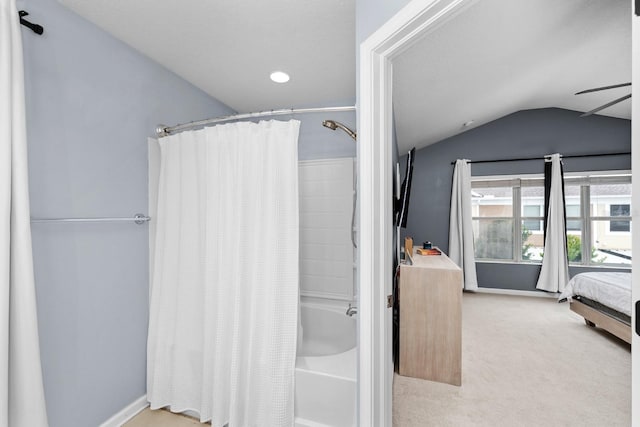 bathroom with ceiling fan, shower / tub combo with curtain, and lofted ceiling