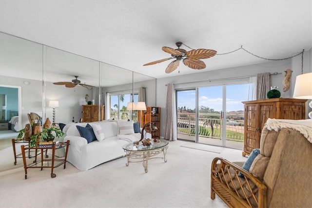 carpeted living room featuring a ceiling fan