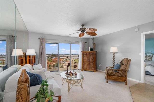 living room with ceiling fan and carpet flooring