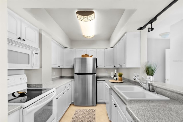 kitchen with white cabinetry, sink, and white appliances