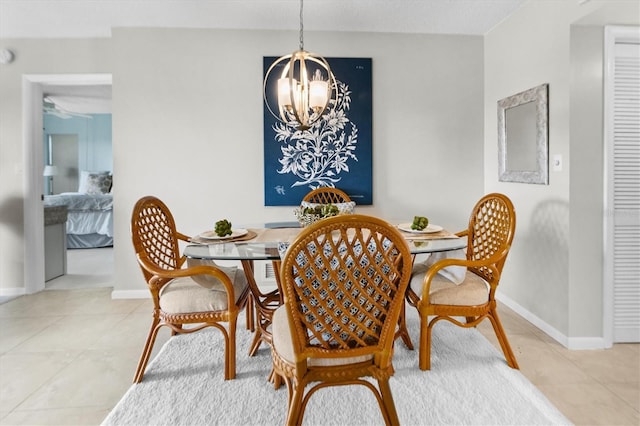 dining area featuring light tile patterned flooring and a chandelier