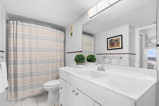 full bathroom with tile patterned flooring, toilet, vanity, tile walls, and shower / bathtub combination with curtain