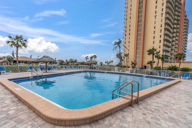 pool with fence, a patio, and a gazebo