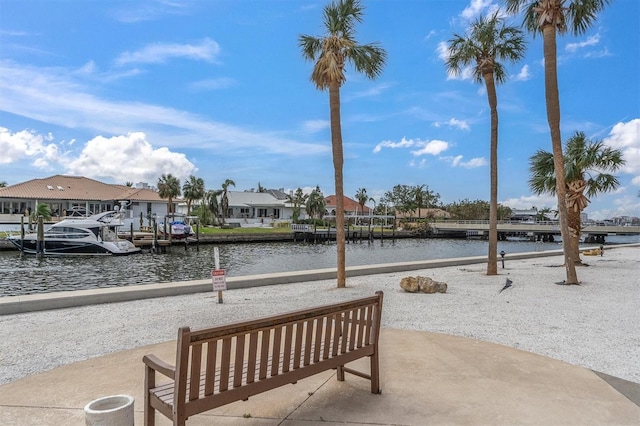 view of property's community featuring a boat dock, a water view, and a residential view