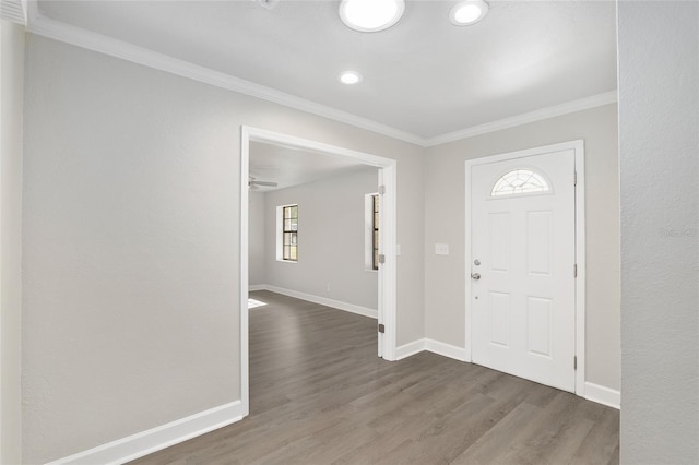 entryway with dark hardwood / wood-style flooring, ceiling fan, and crown molding