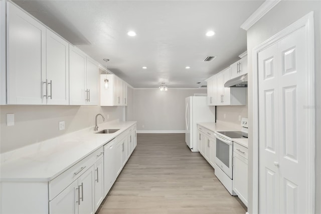 kitchen with white cabinets, white appliances, and light hardwood / wood-style floors