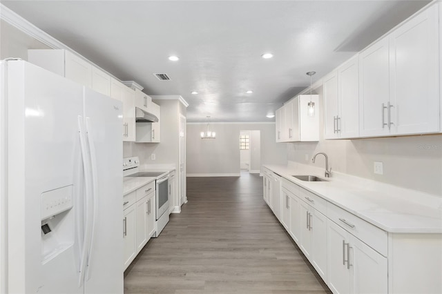 kitchen with white cabinetry, hanging light fixtures, sink, light hardwood / wood-style floors, and white appliances