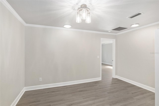 empty room with ornamental molding and dark hardwood / wood-style floors